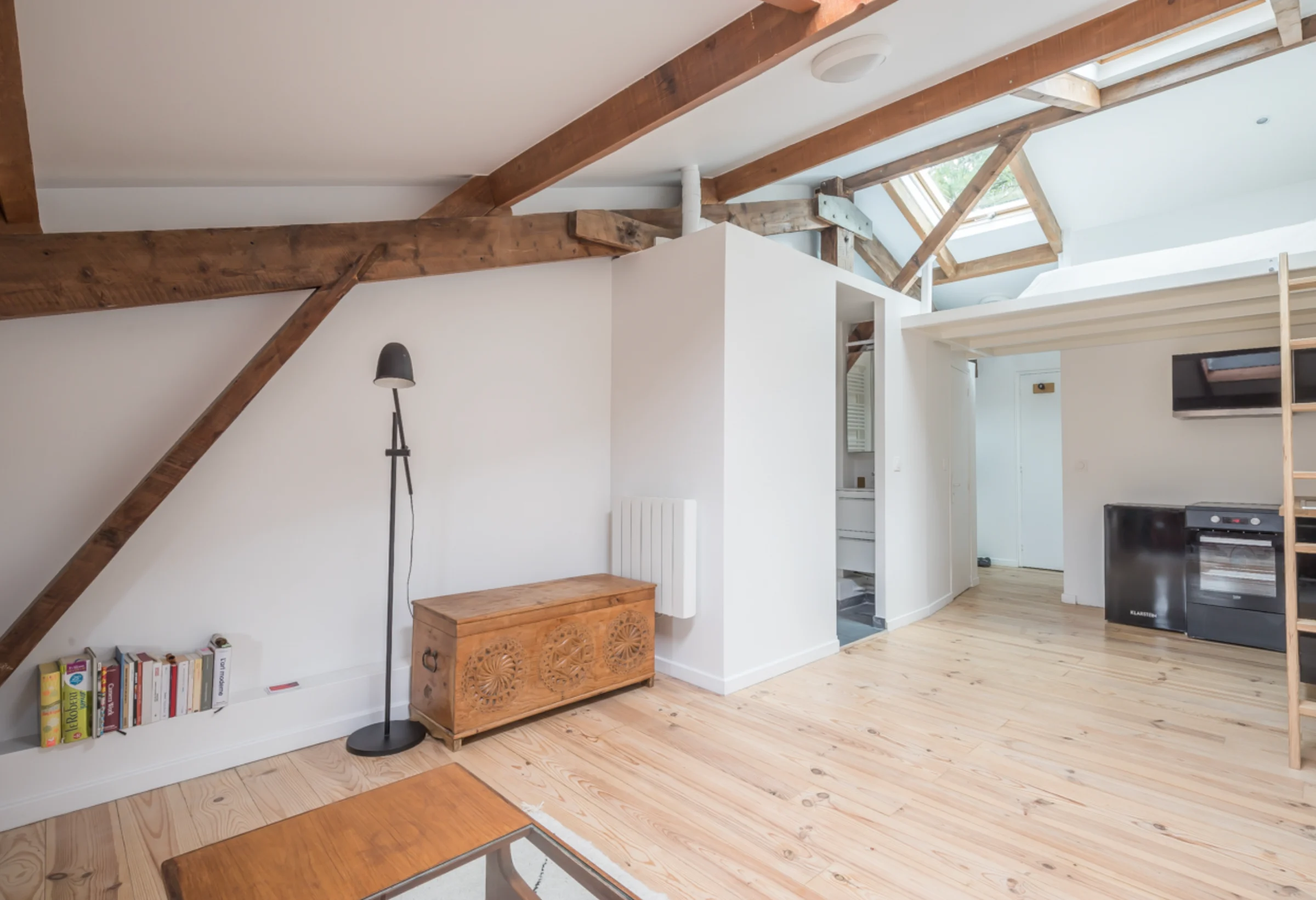 Attic studio with timber beams and mezzanine · 03